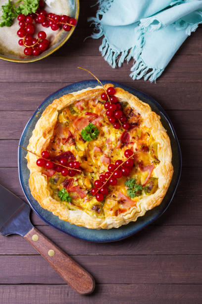 istock Quiche with chunks of ham, creamy brie and vegetables 2194922278