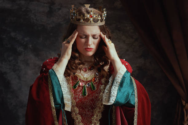 Beautiful mixed race historical african Queen character wearing a period dress in a studio shot
