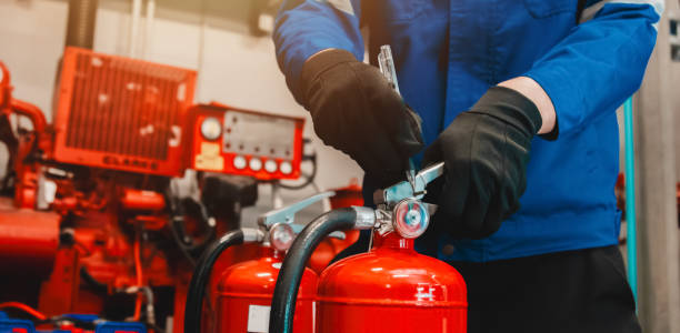 istock Engineer checks fire extinguisher in fire control room to ensure safety. When an emergency occurs 2194922662