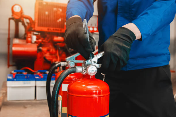 istock Engineer checks fire extinguisher in fire control room to ensure safety. When an emergency occurs 2194922858