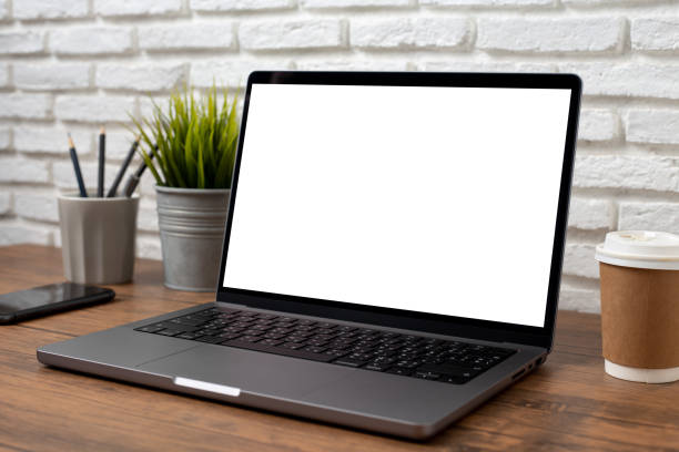 istock mock up empty screen computer on wood desk in home.Notebook Laptop with blank screen 2194923101