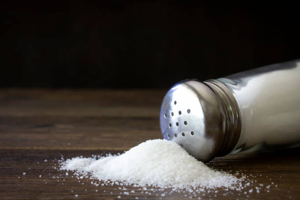 istock Salt on dark wood, close up. 2194927238