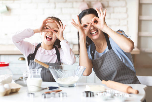 istock Mother and Daughter Enjoy Baking Together While Making Playful Gestures in the Kitchen 2194930498