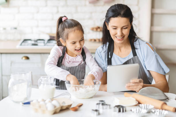 istock Mother and Daughter Enjoying a Baking Session at Home With a Tablet on the Kitchen Table 2194930640