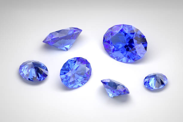 istock Scattering of blue sapphires of different sizes on the white background. Oval cut. 3d rendering. 2194930968
