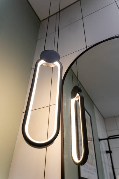 istock In this beautifully decorated space, elegant lights are hung gracefully next to a large, stunningly framed mirror, together creating a warm, inviting, and cozy atmosphere in the entire room 2194932838