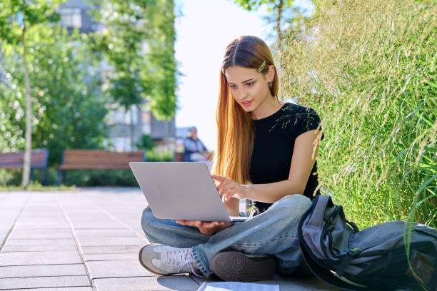istock Young female college student using laptop computer outdoor 2194932977