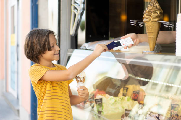 Happy Child Paying for Ice Cream with Card Reader