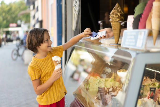 istock Child with Ice Cream Cones Making a Payment Gesture 2194933179