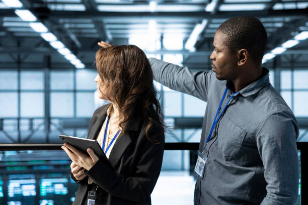 istock Coworkers holding tablet, looking around data center 2194933222