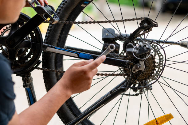 istock A bicycle in a repair shop, rear wheel being repaired, brakes, cassette and drivetrain components. 2194935607
