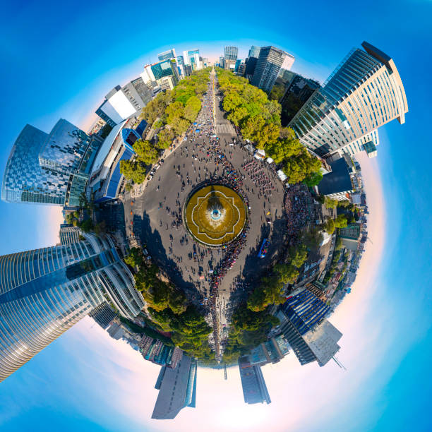 Drone aerial view over the iconic Reforma Avenue packed with people enjoying the annual Catrinas parade next to the La Diana fountain