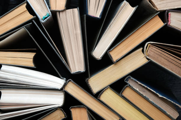 istock Old books on wooden vintage background, top view on binding 2194936552