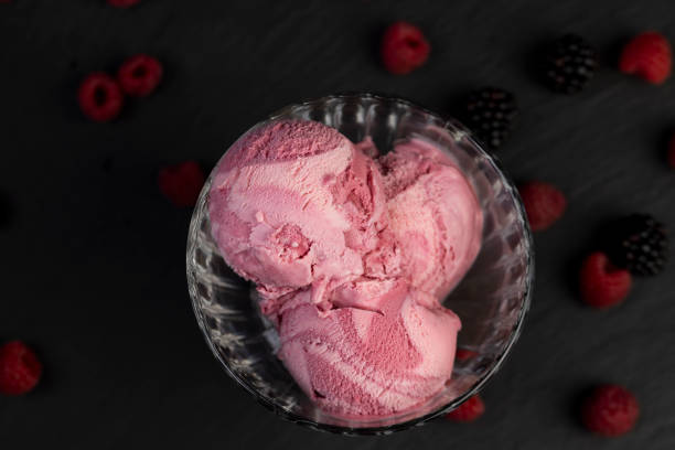 istock raspberry cream ice cream with ripe raspberries and blackberries 2194937761