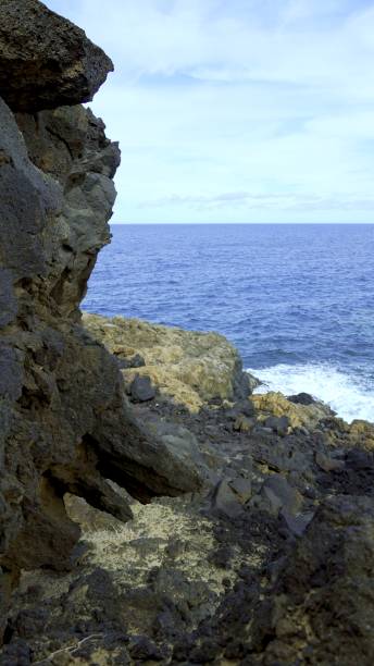 Solidified lava flow by the sea creating a suggestive cliff