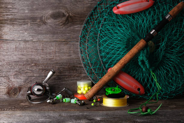 Fishing tackle on  wooden vintage background with copy space,  process of preparing for fishing.