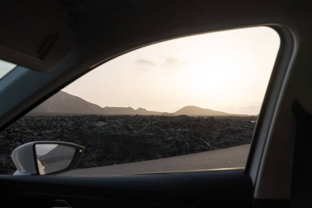 istock Scenic view from a car window at sunset near mountains and lava fields 2194942514