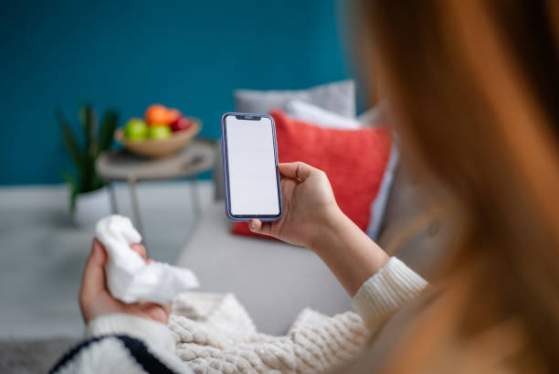 istock Phone in hand, closely held, minimalist home setup. 2194942603
