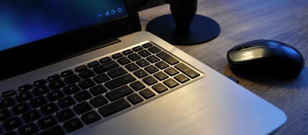 istock Laptop, keyboard, wireless mouse. Close up. Dark wallpaper, dim artificial lighting 2194943860