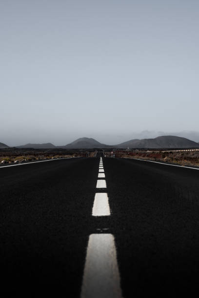 istock Vertical photo empty road stretches towards distant mountains under a calm sky 2194944383