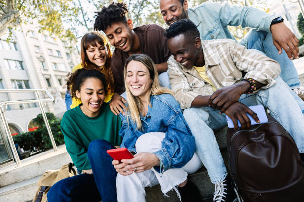 istock Diverse group of friends using mobile phone sitting at urban staircase 2194947579