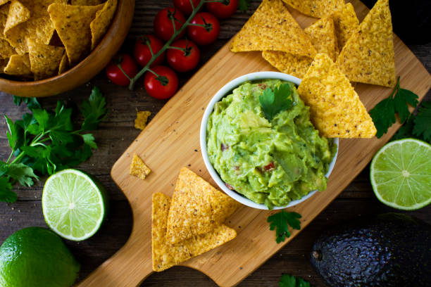istock Guacamole with tortilla chips and limes. 2194948511