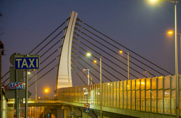 road bridge over railway station during sunset late evening. modern urban architecture during sunset. bridge illumination at night. colorful sky. modern construction, urban construction
