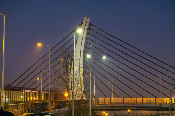 istock road bridge over railway station during sunset late evening. modern urban architecture during sunset. bridge illumination at night. colorful sky. modern construction, urban construction 2194950364