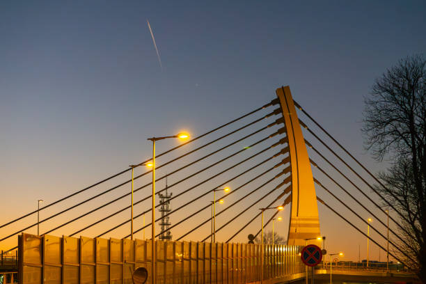 istock road bridge over railway station during sunset late evening. modern urban architecture during sunset. bridge illumination at night. colorful sky. modern construction, urban construction 2194950404