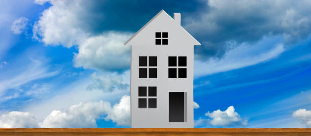 istock Iconic white house silhouette against a vibrant blue sky with clouds, showcasing tranquility and artistic expression in design 2194951820