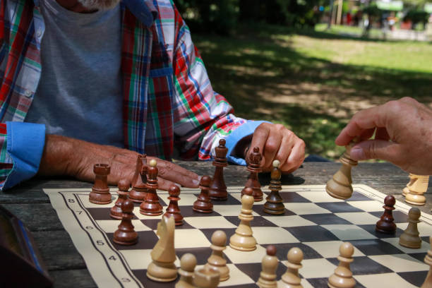 istock Hand of senior man play chess 2194952035