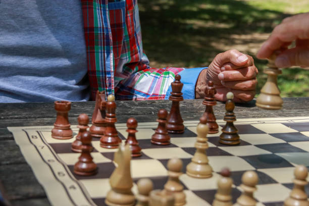 istock Hand of senior man play chess 2194952038