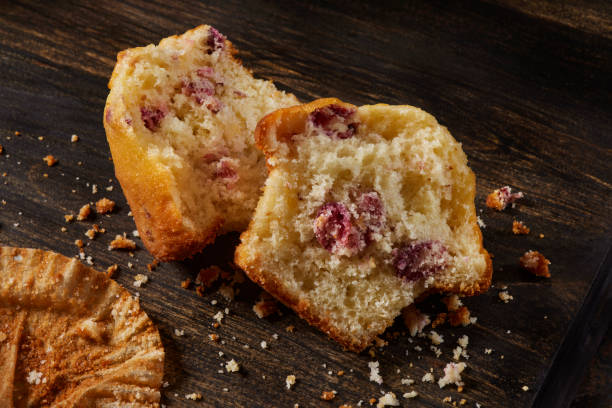 two homemade muffins stacked isolated white background food concept
