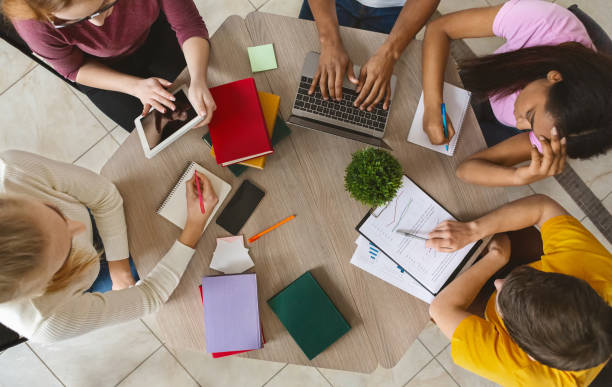 istock Group of Students Collaborating on a Project at a Study Table in a Modern Indoor Space 2194952625