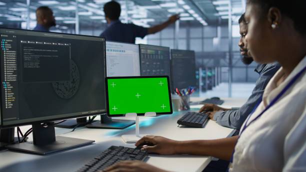 istock Close up of coworkers coding on chroma key device in data center 2194952726