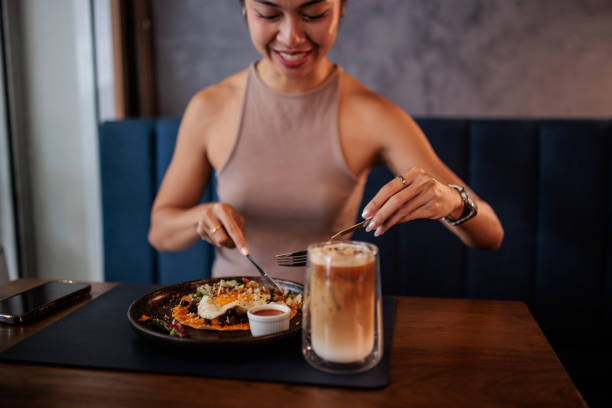 istock Thai Woman Having Breakfast in Cafe 2194953101