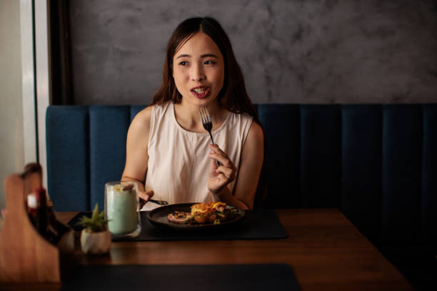 istock Woman Eating a Meal in Cafe 2194953947