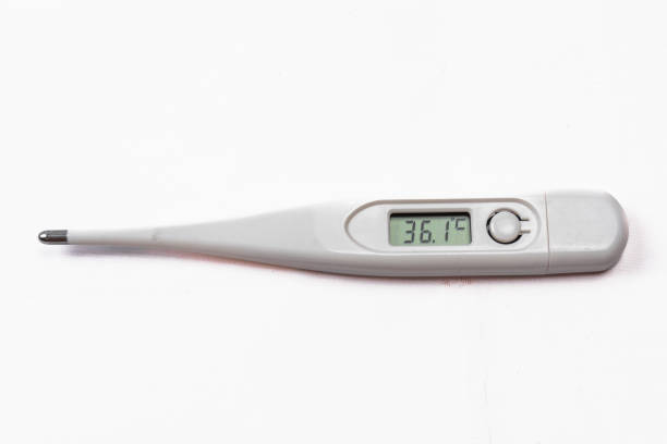 Close up of a man's hand holding a thermometer