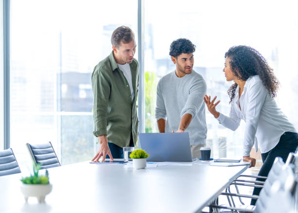 istock Team of three business people working on a laptop computer. 2194957726