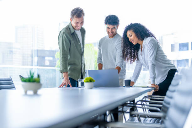 istock Team of three business people working on a laptop computer. 2194957827
