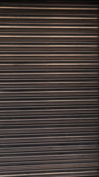 istock Texture of a metal shutter with lines and reflections 2194958283