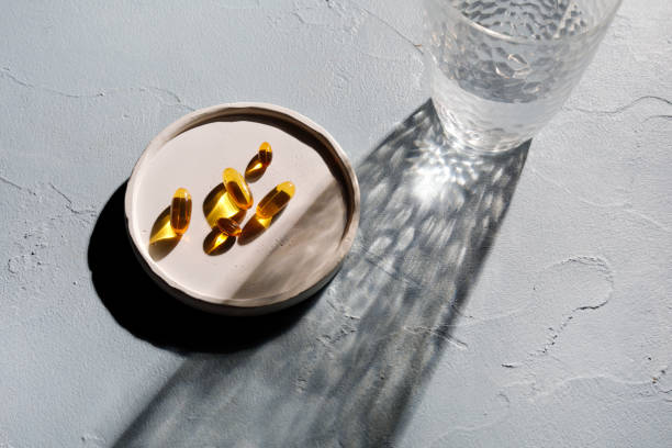 Omega 3 capsules with glass of water