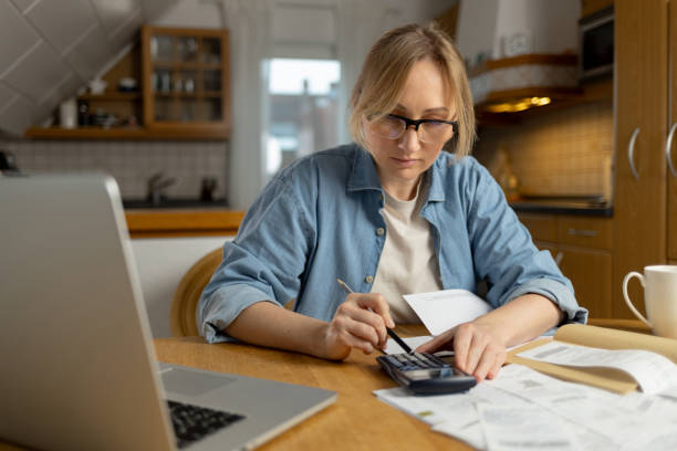 istock verification of accounts helps to avoid mistakes optimize expenses. Attention to detail helps to make decisions. woman studies documents, considering options for improving her financial situation. 2194961076