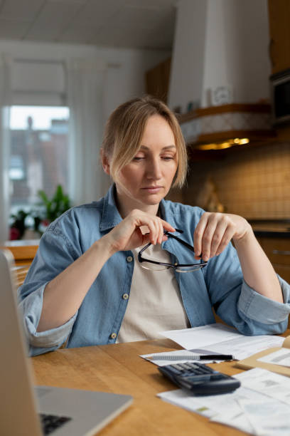 istock verification of accounts helps to avoid mistakes optimize expenses. Attention to detail helps to make decisions. woman studies documents, considering options for improving her financial situation. 2194961113
