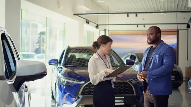 istock Agent persuading hesitant customer to buy vehicle 2194961236