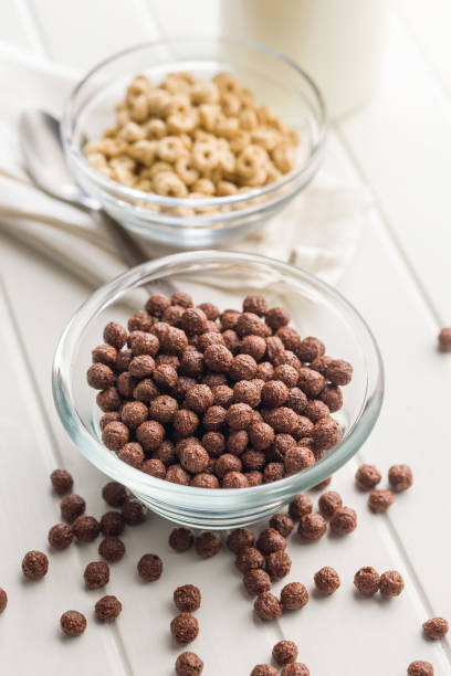 istock Breakfast cereal chocolate balls in bowl on white table. 2194962179