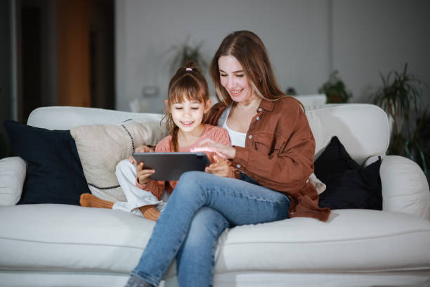 istock Mother and daughter using a digital tablet together 2194968890