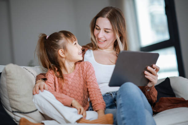 istock Mother and daughter using a digital tablet together 2194969069