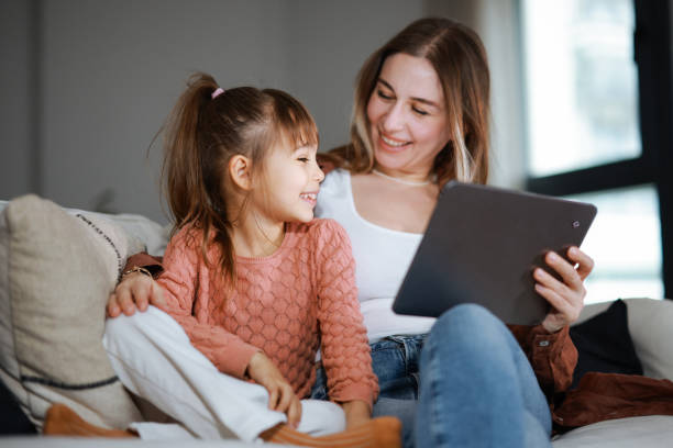 istock Mother and daughter using a digital tablet together 2194970062
