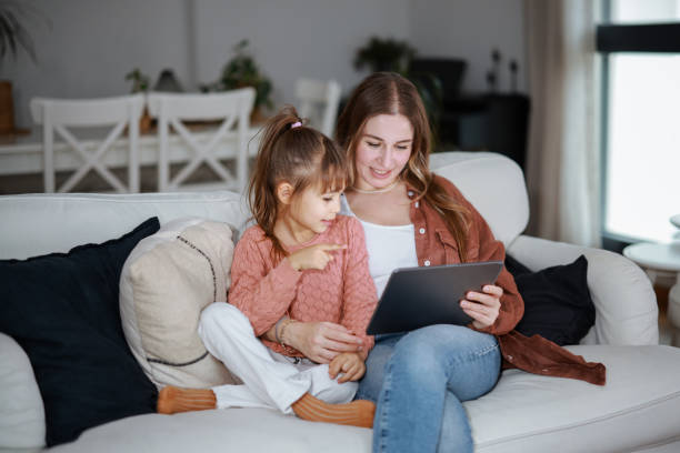 istock Mother and daughter using a digital tablet together 2194970191